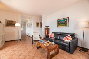 a living room with a couch and a table at Alto Perledo Terrazzo in Perledo