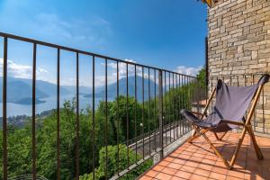 a chair sitting on a balcony with a view at Alto Perledo Terrazzo in Perledo +19 photos