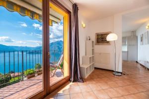 a room with a balcony with a view of the ocean at Alto Perledo Terrazzo in Perledo