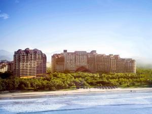 a view of a city with tall buildings and a beach at Pullman Oceanview Sanya Bay Resort & Spa in Sanya