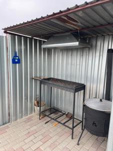 a metal building with a table in a patio at Волна in Balqash