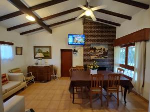 a living room with a table and a ceiling fan at Pinos del Virrey I in Valle Hermoso