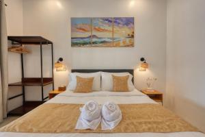 a bedroom with a bed with two towels on it at Nalumi Villa in Nusa Penida +60 photos