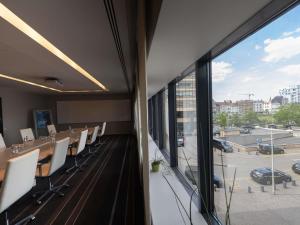 a conference room with chairs and a large window at Pullman Brussels Centre Midi in Brussels