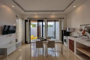 a kitchen with a table and chairs in a room at Nalumi Villa in Nusa Penida