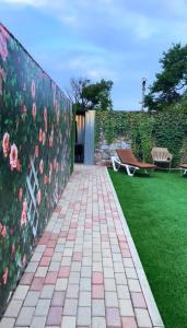a garden with a wall with pink flowers on it at Волна in Balqash +10 photos