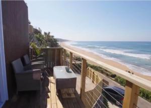 a balcony with a view of the beach at Khayalena Beach House - Tides Reach in Umdloti