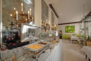 a restaurant with a buffet line with food on it at Apartmenthotel Kaiser Karl in Bonn