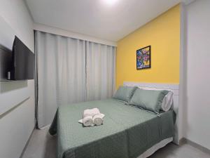 a bedroom with a bed with two towels on it at Life Center in Caruaru +51 photos