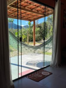 a room with a window with a hammock in it at Casa Jatobá in Ibicoara