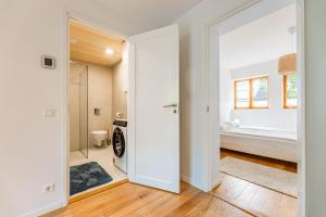 a bathroom with a washer and dryer in a room at Komandandi City Center Apartments in Kuressaare +28 photos