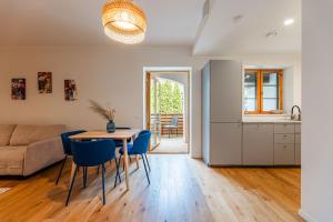 a kitchen and living room with a table and chairs at Komandandi City Center Apartments in Kuressaare