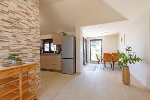 a kitchen and dining room with a brick wall at Apartment House with Shared Pool in Premantura