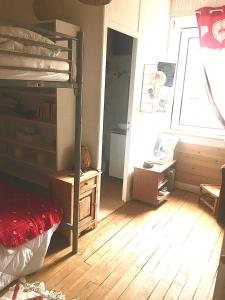 a bedroom with a bunk bed and a wooden floor at T2 Hyper centre le mont dore face thermes et cure in Le Mont-Dore