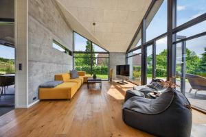 a living room with two couches and a tv at Luxurious Holiday Home with Sauna & Outdoor Hot Tub in Hejls
