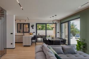 a living room with a couch and a table at Villa Dujma Pool & Spa in Kostrena