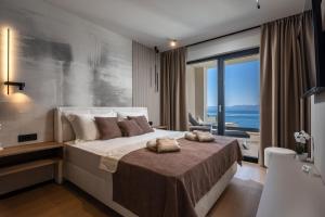 a bedroom with a bed with two towels on it at Villa Dujma Pool & Spa in Kostrena