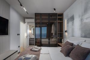 a bedroom with a bed with towels on the floor at Villa Dujma Pool & Spa in Kostrena +40 photos