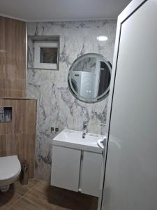 a bathroom with a sink and a mirror at Studio Niki in Smolyan +6 photos