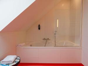 a bathroom with a bath tub in the attic at ibis Styles Saint Brieuc Gare Centre in Saint-Brieuc +51 photos