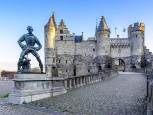 a statue of a man in front of a castle at ibis budget Antwerpen Port in Antwerp