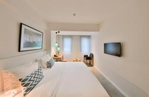 a bedroom with a white bed and white walls at Alilass Hotel in Istanbul