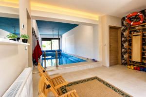 a swimming pool in the middle of a living room at Apartment House with Shared Pool in Premantura