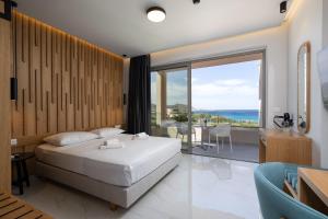 a bedroom with a bed and a view of the ocean at Falasarna Bay Hotel in Falasarna +86 photos
