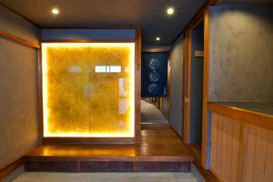 a hallway with a door with a yellow glass window at 樂 Gou in Ise