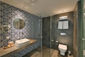 a bathroom with a toilet and a sink and a mirror at Alilass Hotel in Istanbul +51 photos