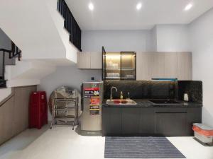 a kitchen with a refrigerator and a sink at Maison Art in Quy Nhon
