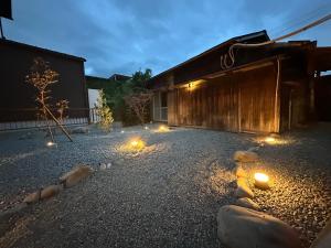 a courtyard with lights in front of a building at 樂 Gou in Ise
