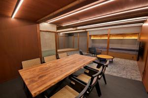 a conference room with a wooden table and chairs at 樂 Gou in Ise