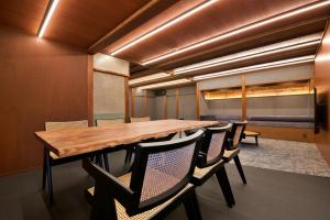 a conference room with a wooden table and chairs at 樂 Gou in Ise +58 photos