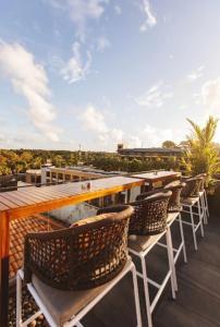 a row of chairs sitting on top of a roof at Rawai Sea Escape 1BR With Rooftop Pool in Rawai Beach