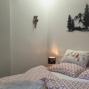 a bedroom with a bed with a teddy bear on the wall at Chalets Dolomiti living in Vergein