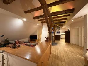 a large living room with wooden ceilings and a couch at Fachwerkliebe Ornes 3 in Olsberg