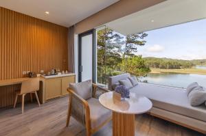 a living room with a couch and a table at Haven in the Pines in Da Lat