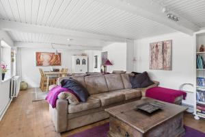 a living room with a couch and a table at Idyllic Old Cottage With Low Ceilings in Bredebro