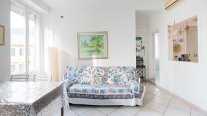 a living room with a chair and a table at Appartamento della Piazza in Levanto +21 photos