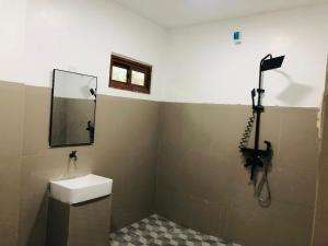 a bathroom with a sink and a mirror at Safe Haven Residence in Talibon