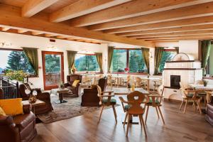 a living room filled with furniture and a fireplace at Hotel Erika in Madonna di Campiglio
