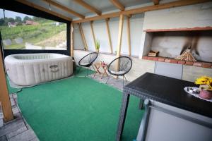 a room with a tub and a table and chairs at Leona in Kamešnica +12 photos