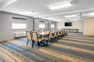a conference room with a table and chairs at Super 8 by Wyndham Perham in Perham