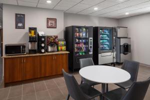 a dining room with a table and a refrigerator at Microtel Inn & Suites - Kearney in Kearney