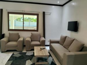 a living room with a couch and a table at Safe Haven Residence in Talibon