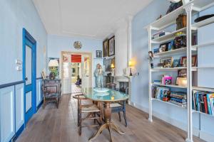 a dining room with a table and bookshelves at Gentle in Bolsward