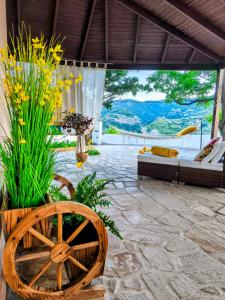 a patio with a table and a chair and flowers at Joanna Studio in Akamatra