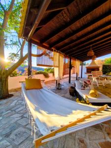 a hammock on the patio of a house at Joanna Studio in Akamatra