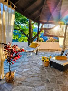 a patio with a table and chairs and a tree at Joanna Studio in Akamatra +29 photos